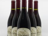 six bottles of red wine are lined up in a row