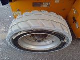 a tire that is sitting on the side of a truck