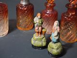 a lot of small glass bottles with figurines on them