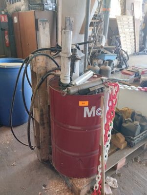 a red barrel with chains on it in a garage