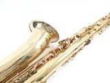 a saxophone that is sitting on a white surface