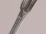 a close up of a spoon and fork on a table
