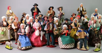 a group of figurines of people dressed in traditional clothing