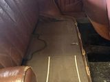 an old car with a leather seat in the back of it