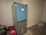 a refrigerator in the corner of a room with a blue door