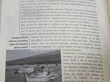 an open book with a picture of a boat in the water