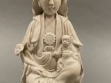 statue of a woman holding a child in her lap