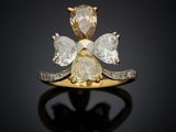 an image of a diamond and gold ring on a black surface