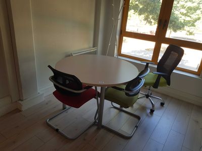 two chairs and a table in the corner of a room