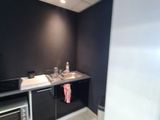 a small kitchen with a microwave and a sink in it