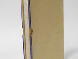 a brown book with a blue strip on the front of it