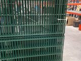 a large green crate sitting in a warehouse filled with pallets