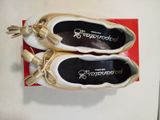 two pairs of shoes that are on top of a red box