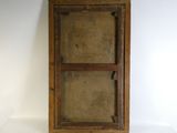 an old wooden cabinet with a glass door on a white surface