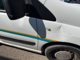 a small white van parked on the side of the road