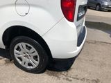 a small white van parked in a parking lot