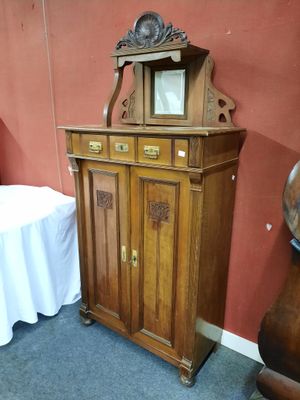 une armoire en bois surmontée d'un miroir