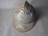 a metal helmet with a bird on it on a table