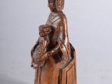 carved wooden statue of a woman holding a baby and a dog