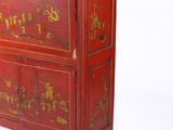a red cabinet that has a gold design on it