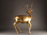 an image of a golden deer statue on a grey background