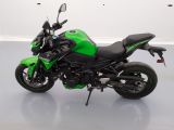a picture of a green and black motorcycle parked in a room