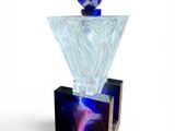 a glass perfume bottle with a blue and purple design on it
