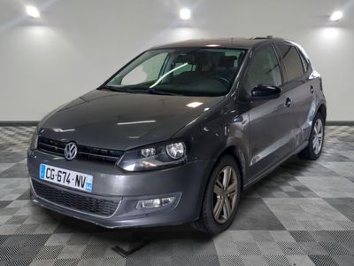 the volkswagen polo is parked in a large room with a checkered floor
