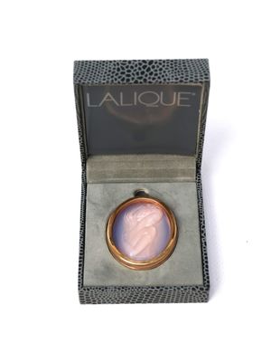 an image of a gold ring with a pink stone in it