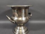 an image of a silver vase with two handles on a black background