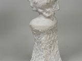 marble bust of a woman in a white dress on a white background