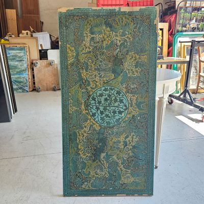 a large green book sitting on top of a wooden stand