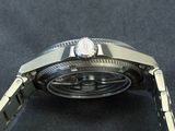 a close up of a watch on a black surface