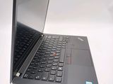 a black laptop with a red button on the keyboard