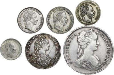 an image of a group of silver coins sitting on top of a white surface