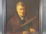 portrait of an old man holding a book in a frame