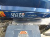 a close up of a blue motorcycle with a box on it