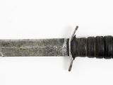 a close up of a knife on a white surface