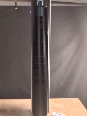 a black tower fan sitting on top of a wooden table