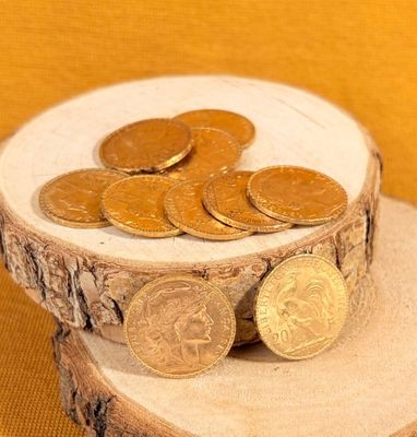 a pile of coins sitting on top of a piece of wood