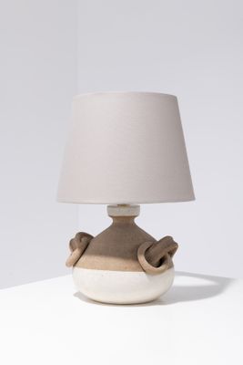 a lamp that is sitting on a table with a lamp shade on it