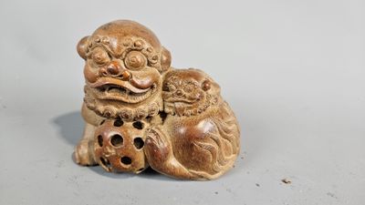 a small figurine of a dog with a ball