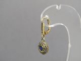 a pair of earrings with a blue stone on them