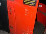 a red machine that is sitting in the garage