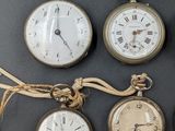 several different types of pocket watches are displayed on a black surface