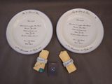 two white plates with writing on them on a table