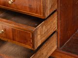 a wooden dresser with three drawers and a mirror