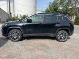 the jeep compass is parked on the side of the road