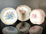 five plates with different designs on them on a table