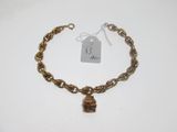 a close up of a gold chain bracelet with a lock on it